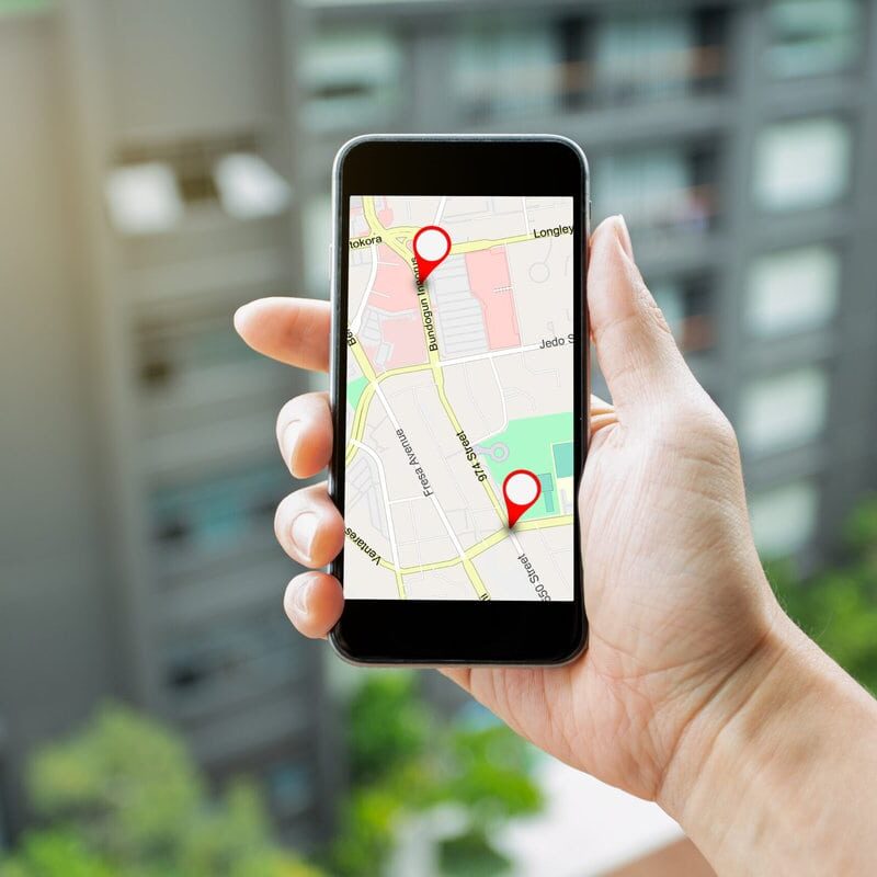 Logistic, geography, transport, travel and navigation GPS Concep Man hand holding smartphone with GPS Map to Route Destination network connection. Location Street Map with GPS Icons Navigation and Red icon of location. Online Navigation Concept.